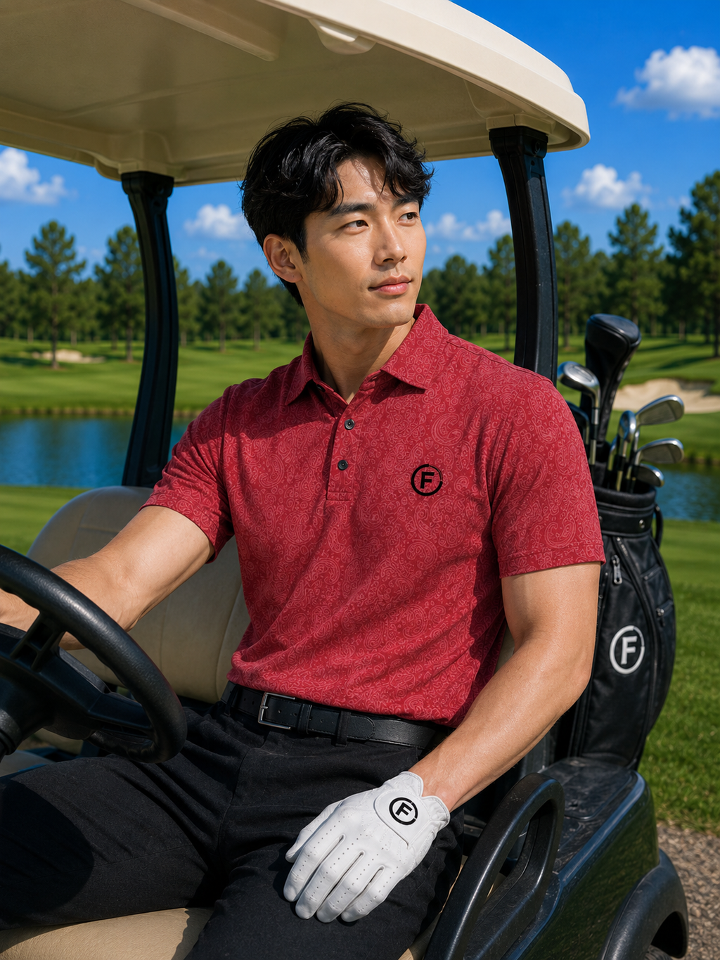 Man in a red polo shirt sitting in a golf cart on a golf course